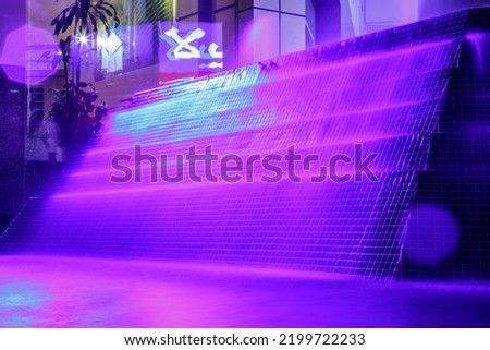 Beautiful purple illuminated fountain at night in Dubai Royalty-Free Stock Photo #2199722233