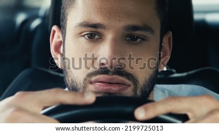 tired man with sweaty forehead driving car while suffering from heat Royalty-Free Stock Photo #2199725013