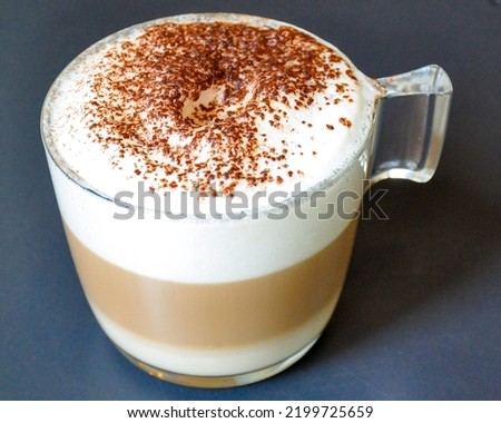 Vegan soy milk cappuccino served in a transparent acrylic cup, against black background Royalty-Free Stock Photo #2199725659
