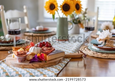 Pretty fall dining table with charcuterie board in the foreground