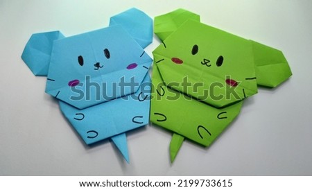 a photo of a cat made of origami paper. colorful and cute