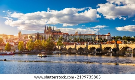 Prague Castle, Charles Bridge and boats on the Vltava river. View of Hradcany Prague Castle, Charles Bridge and a boats on the Vltava river in the capital of the Czechia.  Royalty-Free Stock Photo #2199735805