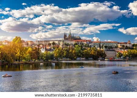 Prague Castle, Charles Bridge and boats on the Vltava river. View of Hradcany Prague Castle, Charles Bridge and a boats on the Vltava river in the capital of the Czechia.  Royalty-Free Stock Photo #2199735811