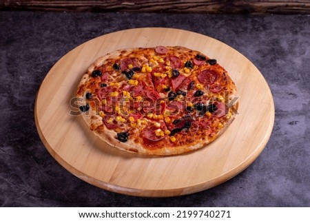 Pizza. Traditional Italian cuisine delicacies. mixed pizza on dark background