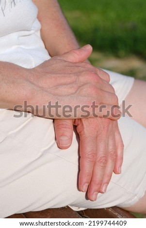 Mid age adult woman's hands,hands of mature woman sitting in the park