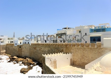 ancient buildings on the side of the ocean in the old medina of Assilah