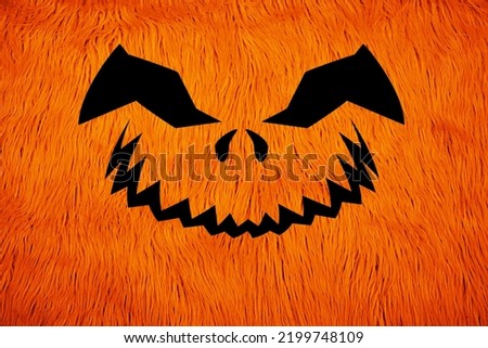 Cute lantern jack Smile on orange background. Artificial fur orange carpet. Fluffy fur texture for background. Wool-like fiber fabric. Halloween horrible carved pumpkin concept.