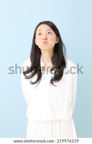 happy young woman against blue background