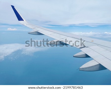 Wings of an airbus type airplane, the photo was taken from inside the plane while it was in the air.