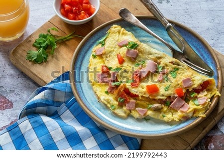 Egg omelette with ham, mushrooms and tomatoes Royalty-Free Stock Photo #2199792443