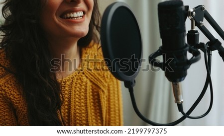Young woman dubbing voiceover for broadcast stream live show