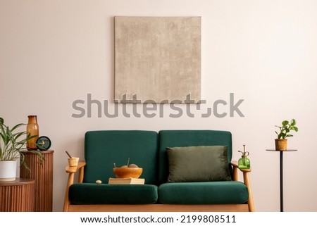 Elegant living room with mock up, bottle green sofa, wooden coffee table, decorations and plants. Mock up poster. Home decor. Template. 