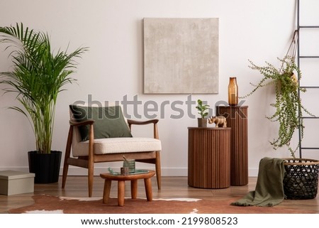 Elegant and bright space of living room with mock up poster, wooden coffee table, plant
 and beige armchair with green pillow. Beige wall. Home decor. Template. 