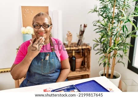 Senior african american woman communicating with deaf language at art studio