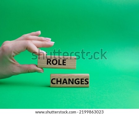Role changes symbol. Concept words Role changes on wooden blocks. Beautiful green background. Businessman hand. Business and Role changes concept. Copy space.