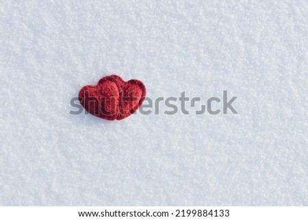 two red hearts on a snowy background, valentines day background, love winter