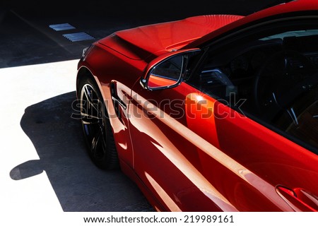 Luxury red car details view, elegant and beautiful Royalty-Free Stock Photo #219989161