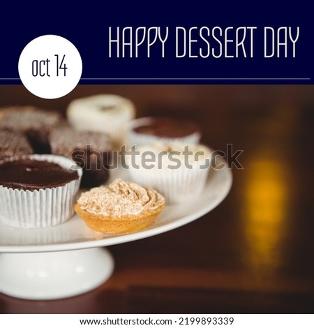 Composition of happy dessert day text over muffins. Dessert day and celebration concept digitally generated image.
