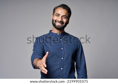 Smiling indian business man investor, happy ethnic businessman employer, professional hr manager or salesman extending hand for handshake welcoming offering cooperation isolated on gray, portrait. Royalty-Free Stock Photo #2199901075