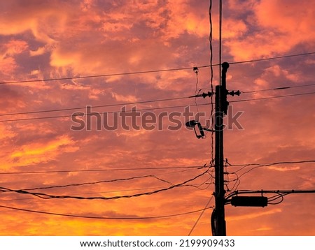 Morning Sunrise behind a Telephone Pole Royalty-Free Stock Photo #2199909433