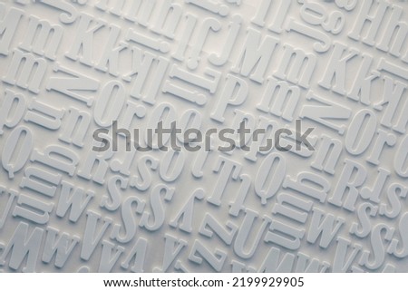 white alphabe letter background overhead view Royalty-Free Stock Photo #2199929905