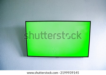 tv with green background on the wall