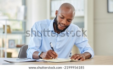 Businessman writing in a notebook while planning a strategy and working in an office. Happy male professional reading and write market search result and work updating schedule at a corporate company Royalty-Free Stock Photo #2199956185