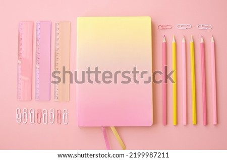 Back to school supplies stationery on pink background, flat lay, top view. Education accessories, pencils, rulers and notebook stuff geometric layout. Flatlay from above. Stationary sales advertising