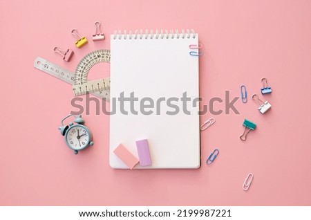 School supplies accessories, clock and notebooks on pink background, flat lay top view. Stationery education supplies accessories discount sales. Back to school, get ready for learning. Copy space.