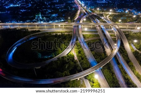 Aerial view of road interchange or highway intersection of Expressway top view, Road traffic an important infrastructure, car traffic transportation above intersection road in city night. Royalty-Free Stock Photo #2199996251