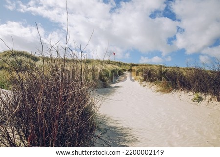 Path on a North Sea island on the North Sea. Holiday at the North Sea. Hiking on vacation