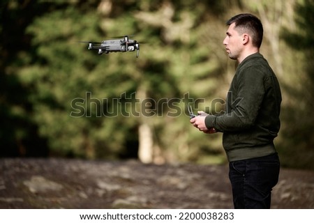 Drone pilot, quadcopter flight control with manual control panel, drone at human eye level