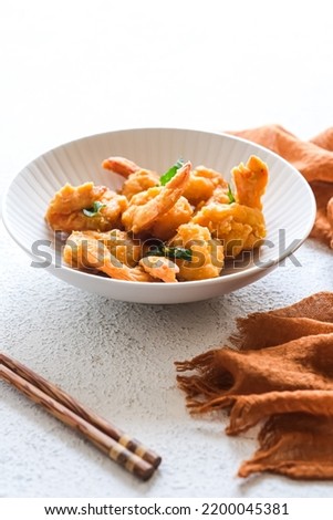Salted egg fried prawns in white ceramic bowl

