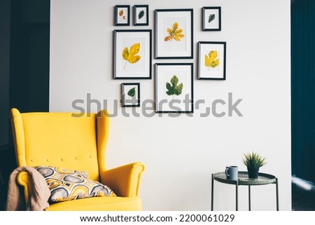 Multiple many black picture frames on white wall. Royalty-Free Stock Photo #2200061029
