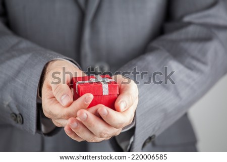 Businessman Holding Red Gift Box