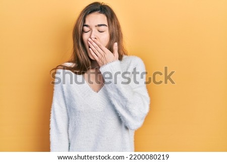 Young caucasian girl wearing casual clothes bored yawning tired covering mouth with hand. restless and sleepiness.  Royalty-Free Stock Photo #2200080219