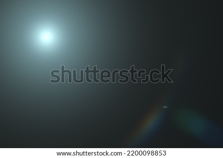 Glare of optics of sun or bright object to overlay on image. Lens flare light over black background. Easy to add overlay or screen filter over image