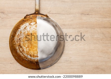A frying pan that is half burnt and half polished Royalty-Free Stock Photo #2200098889