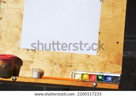 easel for drawing pictures. Brushes and paints