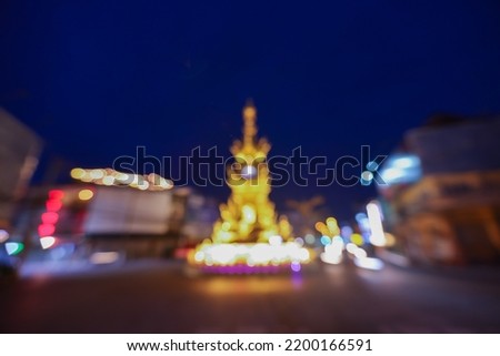 Blur bokeh background of chiang rai lighting clock tower in twilight time, the most famous of local landscape traveling of Chiang Rai, Thailand