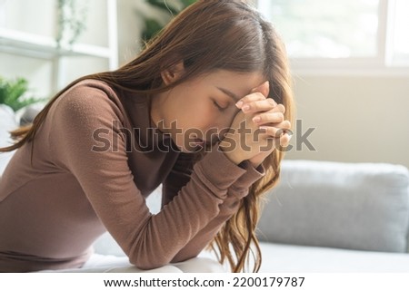 Believe faith charity, calm asian young woman show gratitude, folded hands in prayer feel grateful, meditating with her eyes closed, praying to request God for help. Religious, forgiveness concept. Royalty-Free Stock Photo #2200179787