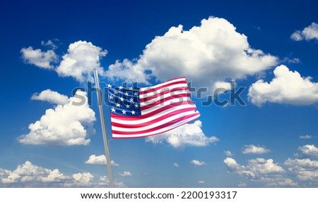 United States national flag waving in beautiful clouds.