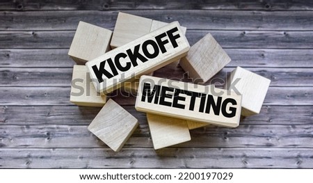 Kick-off meeting text on wooden blocks on wooden background .Money, business and finance concept Royalty-Free Stock Photo #2200197029