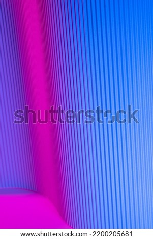 Abstract geometric background with pink and blue hues. Corrugated lines futuristic backdrop.