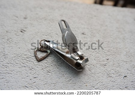A nail clipper  is a hand tool used to trim fingernails, toenails and hangnails.