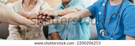 Background of elderly human bare hands join together in the middle under with indoors light. Concept Elderly nursing care help and support. Service mind for senior people. Royalty-Free Stock Photo #2200206253