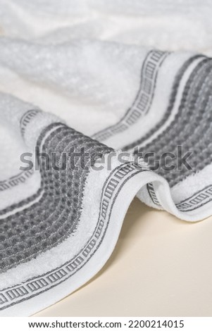 Towel texture close up. Terry cloth bath or beach towel. Soft fluffy textile. Top view. White towel macro material. Decor element. Beautiful ornament.