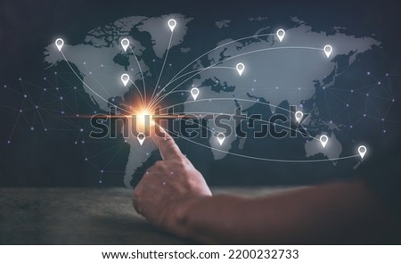 Connecting global travel location technology, Destination points. Map pointer navigation concept, Hand pointing at the location on virtual world map, GPS navigator. Royalty-Free Stock Photo #2200232733