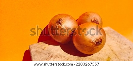 onions "bawang bombay" on an orange background