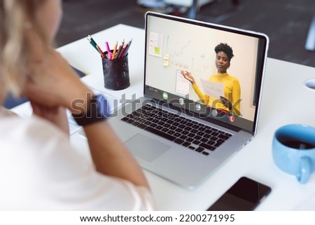 Caucasian businesswoman having video call with colleague. Global business and digital interface concept, digital composite image.